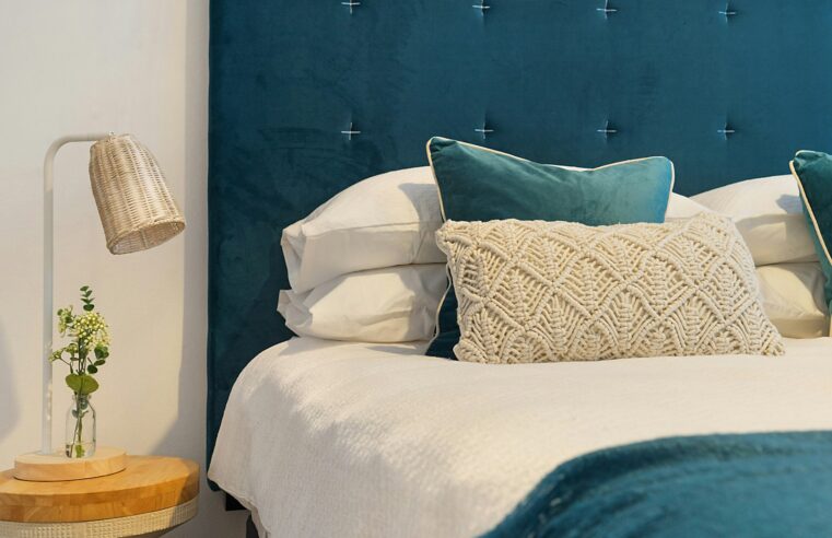 blue bed and mattress with pillows